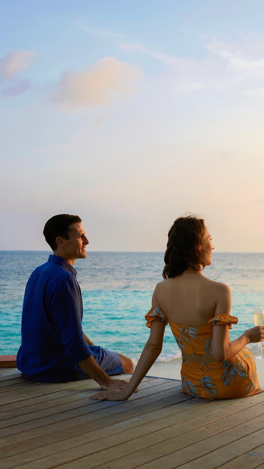 Couple watching sunset in the Maldives